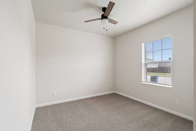 carpeted spare room featuring ceiling fan