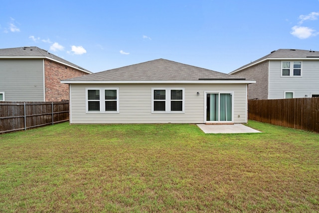 rear view of house featuring a lawn and a patio area