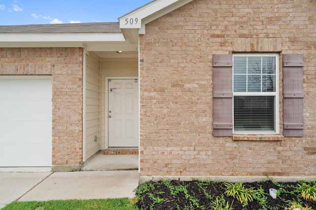 view of exterior entry featuring a garage