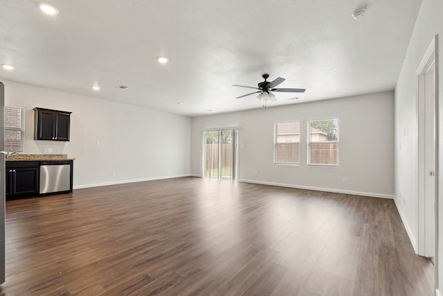 unfurnished living room featuring dark hardwood / wood-style floors, sink, and ceiling fan