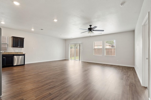 unfurnished living room with recessed lighting, baseboards, a ceiling fan, and dark wood-style floors