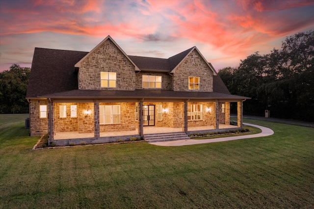 back house at dusk with a lawn