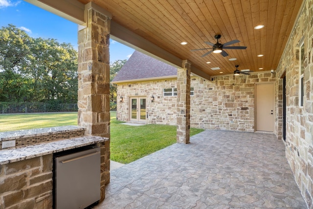 view of patio with exterior kitchen and ceiling fan