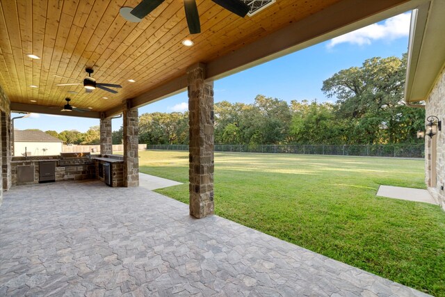 view of patio / terrace featuring ceiling fan and exterior kitchen