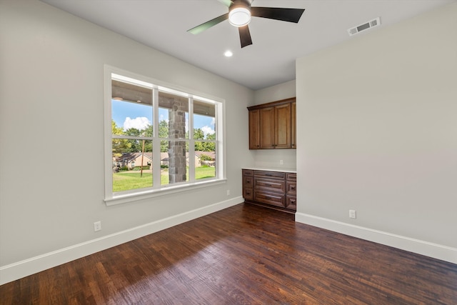 empty room featuring ceiling fan and dark hardwood / wood-style floors