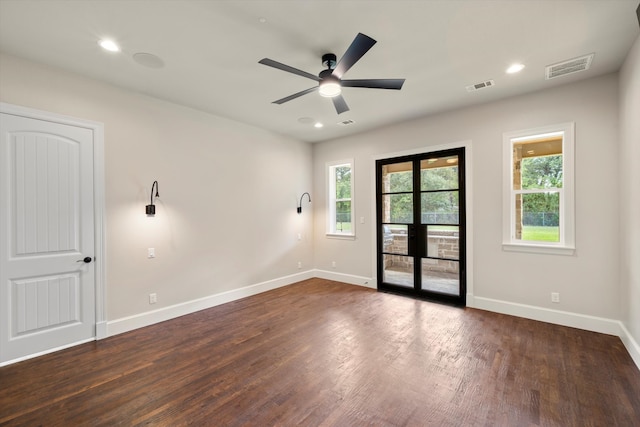 empty room featuring ceiling fan and dark hardwood / wood-style floors