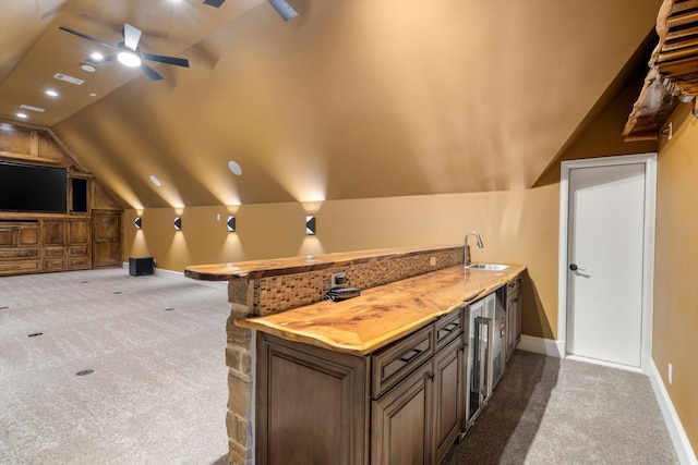 interior space featuring lofted ceiling, sink, and ceiling fan