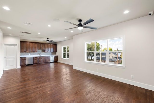 unfurnished living room with dark hardwood / wood-style floors and ceiling fan