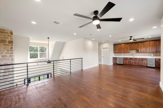 unfurnished living room with sink, ceiling fan, and dark hardwood / wood-style flooring