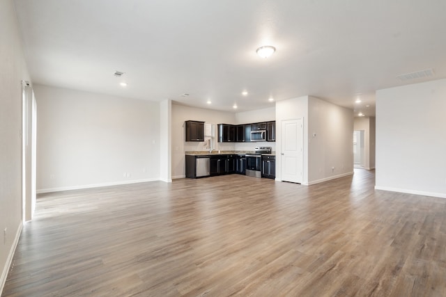 unfurnished living room with hardwood / wood-style floors