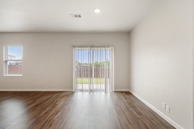 spare room with dark hardwood / wood-style floors