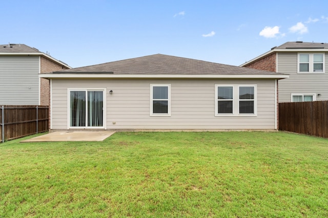 rear view of house with a yard and a patio area