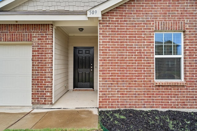 doorway to property with a garage