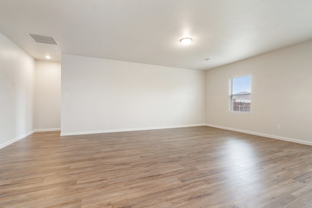 empty room with light hardwood / wood-style floors