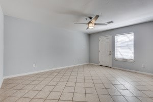 tiled empty room with ceiling fan