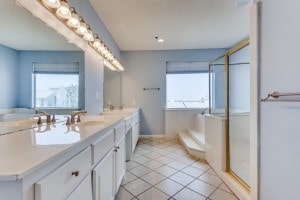 bathroom with vanity, shower with separate bathtub, and tile patterned flooring