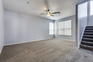 spare room featuring ceiling fan, plenty of natural light, and carpet flooring