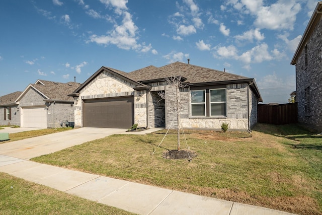 view of front of home featuring a front yard and a garage