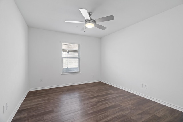 spare room with ceiling fan and dark hardwood / wood-style flooring