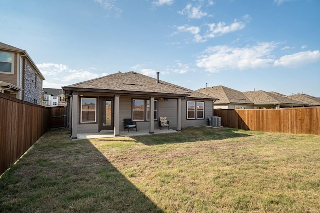 back of house with a lawn, a patio, and central AC unit