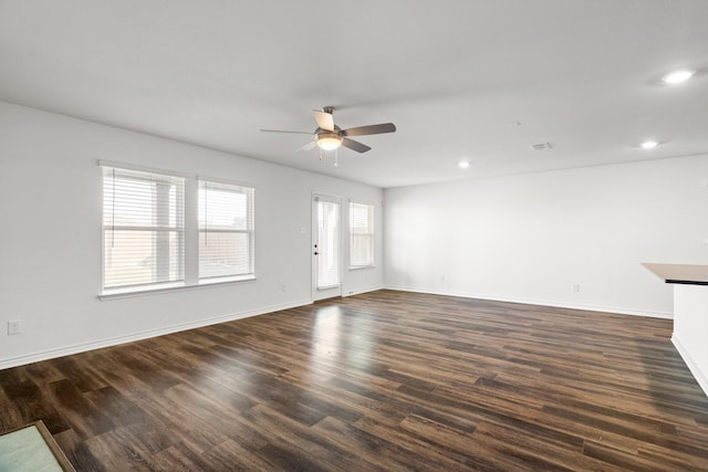 unfurnished living room with ceiling fan and dark hardwood / wood-style floors