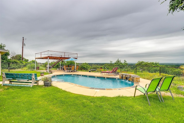 view of pool featuring pool water feature, a lawn, and a patio area