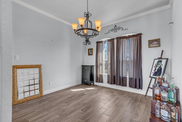 555 Mastadon Way, Weatherford, TX 76085 - dining space featuring wood finished floors, crown molding, and a chandelier