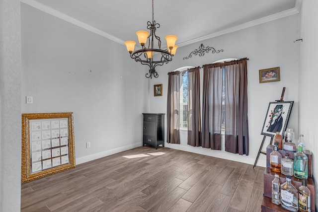 interior space featuring a notable chandelier, ornamental molding, and hardwood / wood-style flooring