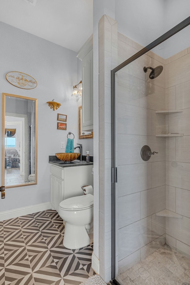 bathroom with walk in shower, vanity, and toilet