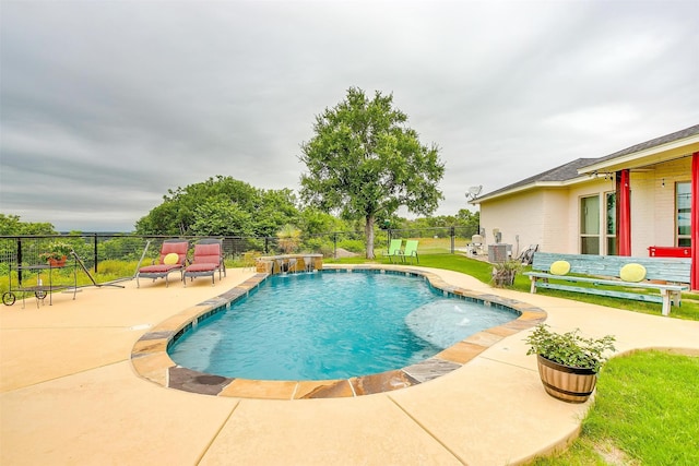 view of swimming pool with a patio and pool water feature