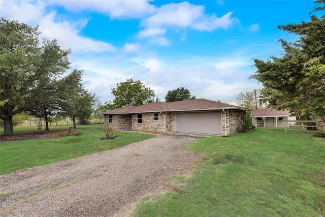 ranch-style house with a garage and a front lawn