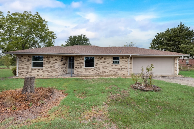 single story home with a garage and a front lawn