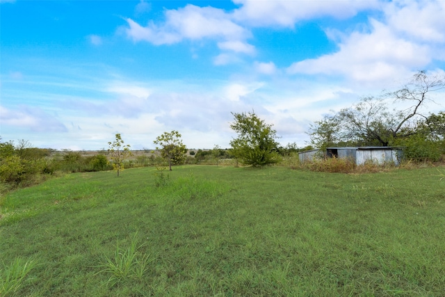 view of yard with a rural view