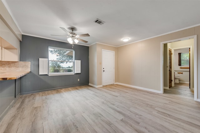 unfurnished living room featuring ornamental molding, light hardwood / wood-style flooring, and ceiling fan