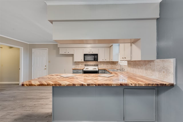 kitchen with kitchen peninsula, stainless steel range with electric stovetop, white cabinetry, and tasteful backsplash