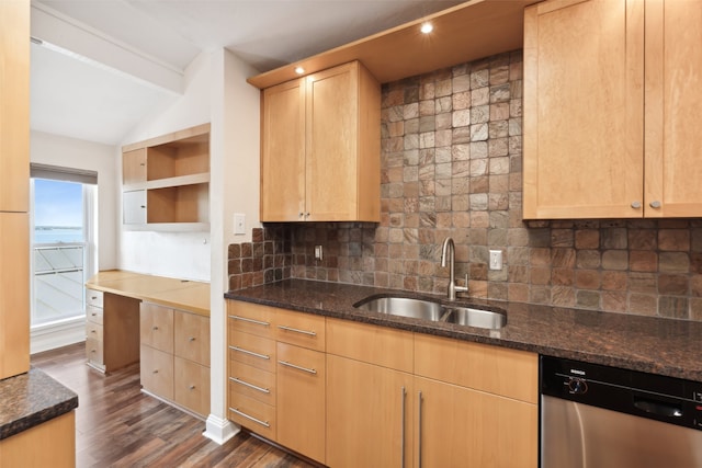 kitchen with sink, dark hardwood / wood-style flooring, stainless steel dishwasher, dark stone countertops, and decorative backsplash