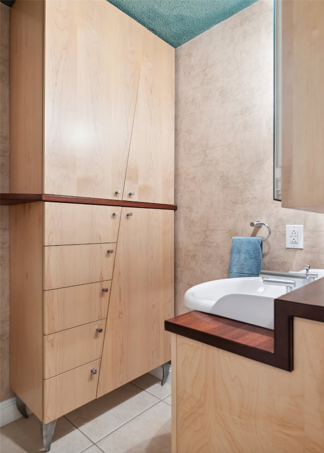 bathroom featuring a textured ceiling, vanity, and tile patterned floors