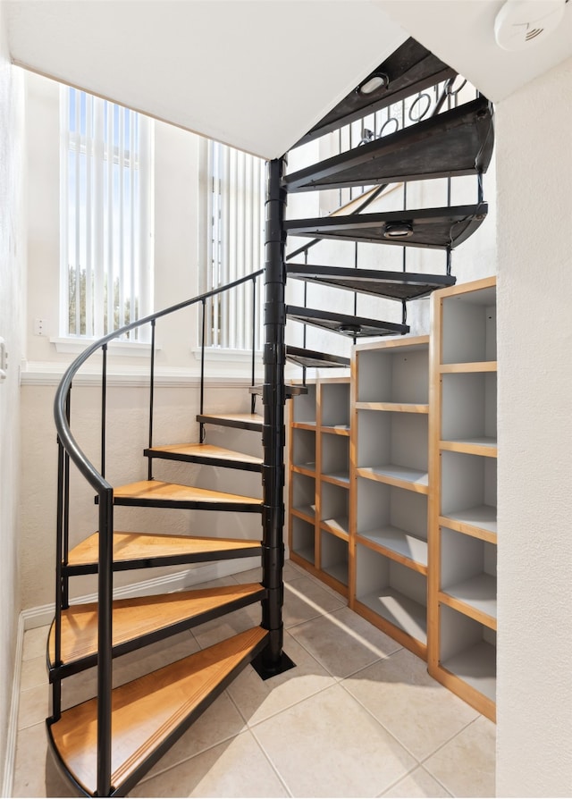 stairs featuring tile patterned flooring