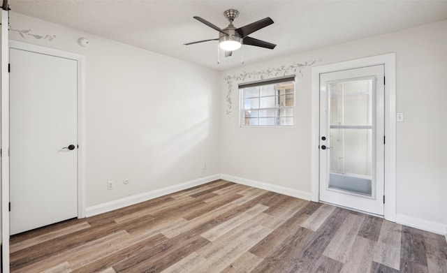 unfurnished room featuring ceiling fan and light wood-type flooring