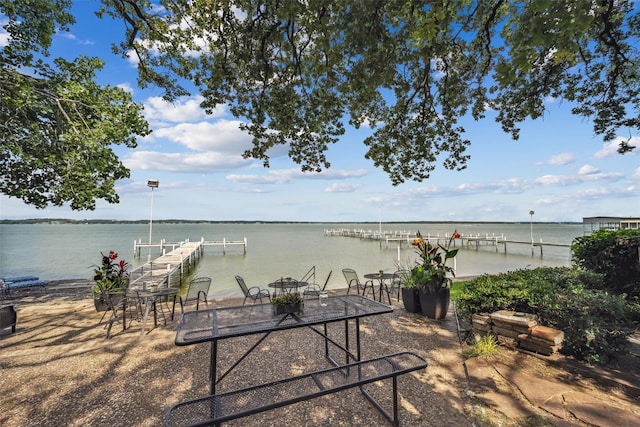 exterior space featuring a boat dock and a water view