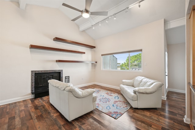 living room featuring rail lighting, dark wood-type flooring, ceiling fan, and lofted ceiling