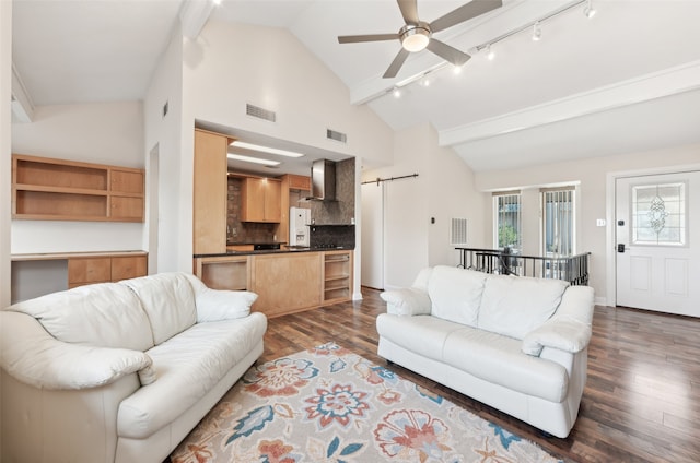 living room featuring dark hardwood / wood-style flooring, rail lighting, ceiling fan, a barn door, and high vaulted ceiling