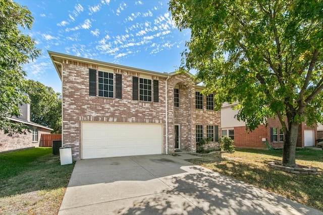 view of front of property with a front yard and a garage