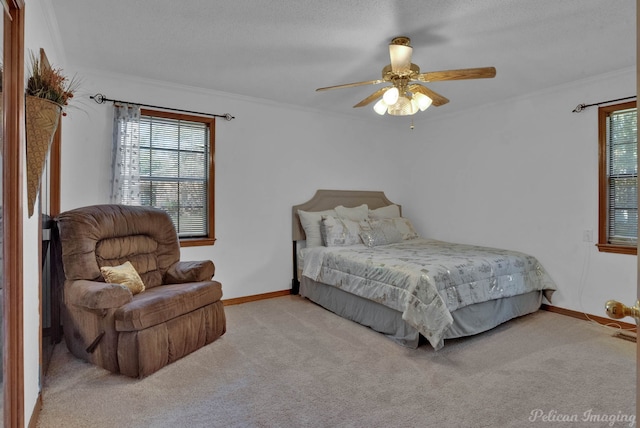 carpeted bedroom with ceiling fan, ornamental molding, and a textured ceiling