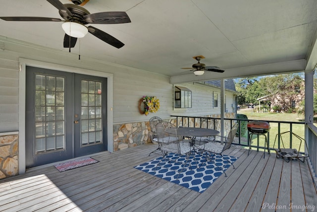 wooden deck with a yard and french doors