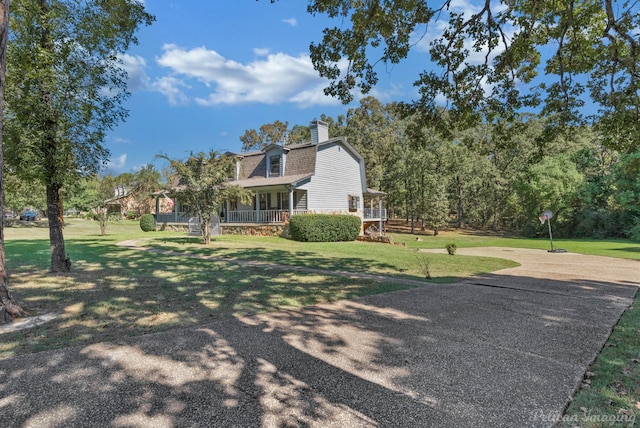 exterior space with covered porch and a front yard