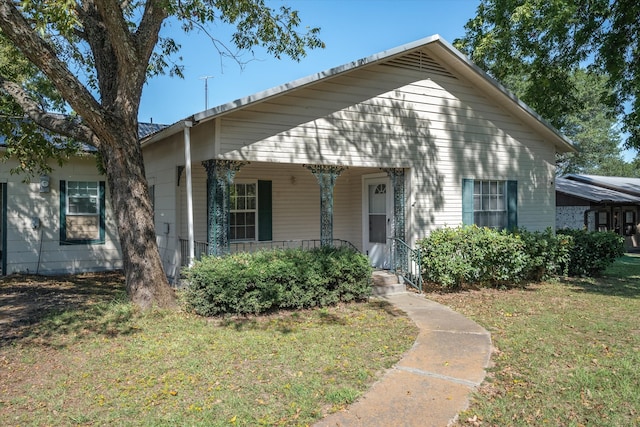 bungalow-style home featuring a porch and a front yard