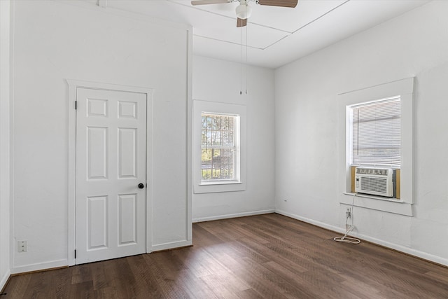 spare room with ceiling fan, cooling unit, and dark hardwood / wood-style floors