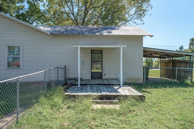 back of house with a deck and a lawn