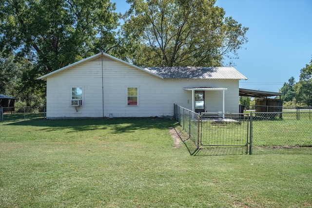 view of property exterior featuring cooling unit, a carport, and a lawn